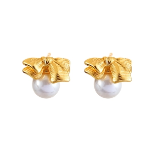 Elegant gold bow earrings with white pearls in a minimalist vintage style design
