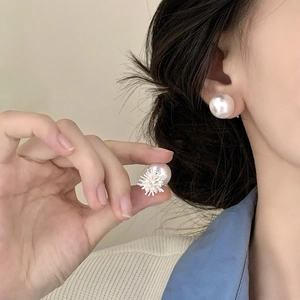 Elegant irregular firework pearl earrings with high luster on model in natural light