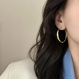 Fashionable gold twist hoop earrings with geometric irregular texture for women