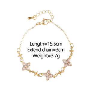 Detail of gold clover bracelet with pink zircon pendants, 15.5cm length and star accents