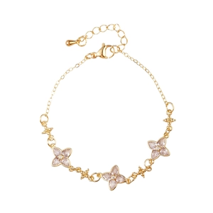 Elegant gold flower bracelet with pink zircons and adjustable lobster clasp on white background