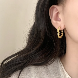 Irregular gold twisted hoop earrings with braided texture for a stylish daily look