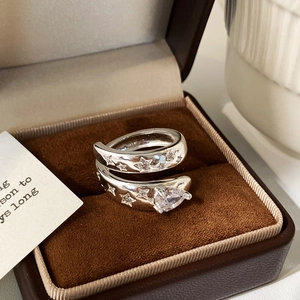 Macro view of a silver ring featuring star engravings and a pear-cut cubic zirconia stone