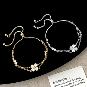 Adjustable flower bracelets with cat eye stones and zircons on a black velvet stand