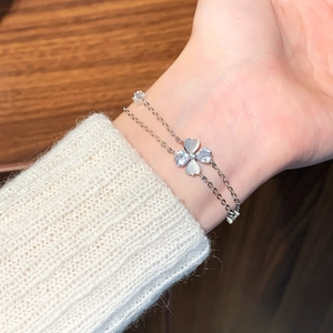 Elegant silver flower bracelet with zircon and cat eye stone on female wrist