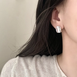Minimalist square geometric silver stud earrings for women shown on female model