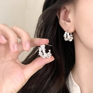 Retro C-shaped irregular silver earrings with sparkling zircon clusters on model
