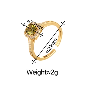 Detail of gold open ring with square lime green gemstone and zircon accents
