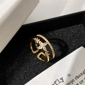 Detailed macro view of a gold double-layer star ring with micro-pave diamonds on black velvet