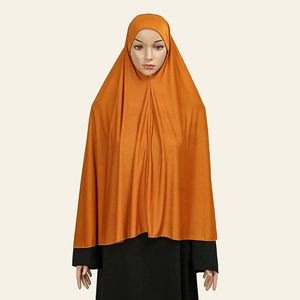 Detail view of ginger yellow Muslim khimar hijab showing the smooth 40D crystal linen drape