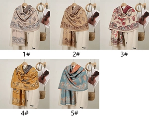 Detail view of five paisley pattern cashmere-like pashmina shawls with tassel fringes