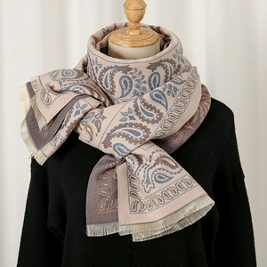 Thick paisley cashmere shawl with tassels on a mannequin, winter ethnic style scarf