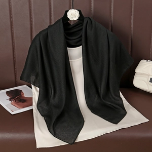 Detail of premium black cotton linen square scarf paired with a satin sleeveless top