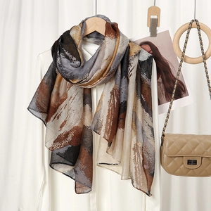 Close-up of lightweight printed scarf with abstract brushstrokes on a white shirt