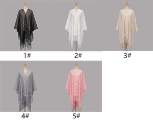 Close-up of elegant floral lace embroidery and matching tassels on soft polyester capes