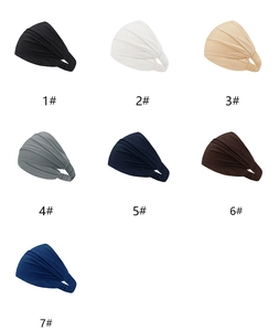 Detailed flat lay of wide elastic cotton headbands in seven solid colors and pleated finish