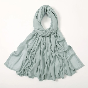 Close-up of sage green modal scarf showing soft breathable fabric and natural pleated texture