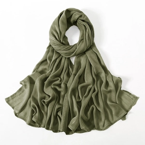 Macro shot of olive green modal scarf fabric showing soft texture and fine hemmed edges
