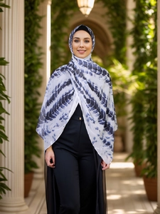 Detail of ethnic tie-dye chiffon hijab showing blue wave pattern on white fabric