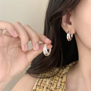 Elegant silver layered geometric hoop earrings with glitter texture shown on model