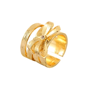 Minimalist gold bow-shaped open ring with textured band and single central zircon stone