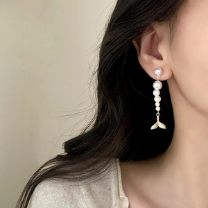 Elegant French style long pearl tassel earrings with golden fishtail pendant on model
