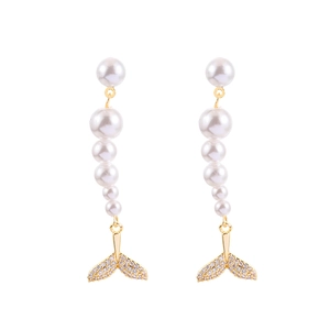 Elegant long pearl tassel earrings with crystal fishtail pendants on a white background