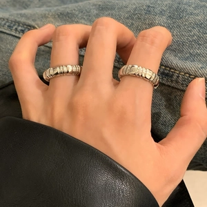 Minimalist silver threaded facet open rings for women on denim and leather background