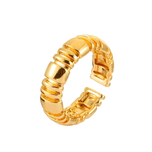 Detail of adjustable gold ring with unique ribbed texture and mirrored metallic finish