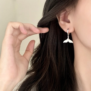 Elegant silver fishtail drop earrings for women shown on model for a minimalist style
