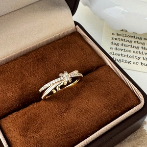 Elegant 18K gold plated bow ring with white cubic zirconia in a brown jewelry box