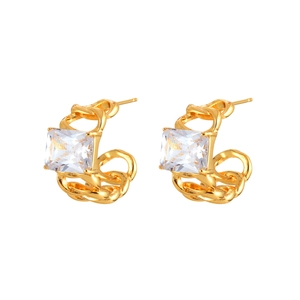 Macro detail of gold C-shaped chain earrings featuring rectangular zircon stone settings