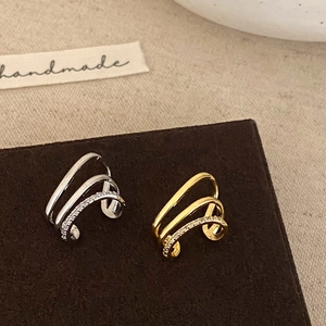 Three-layer ear cuff set in gold and silver with zircon accents and a minimalist design