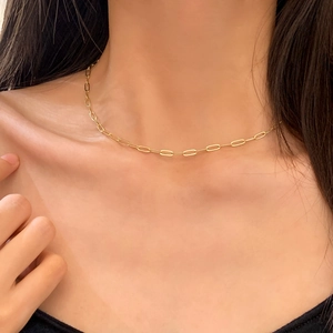 Gold minimalist thin chain necklace for women worn on the neck with a metallic finish