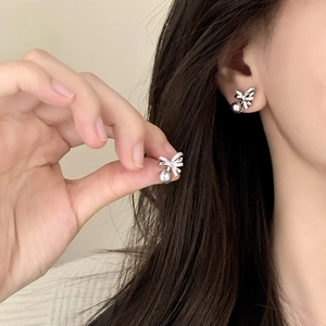 Elegant bow knot pearl earrings with sparkling crystals and a smooth grey pearl drop