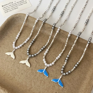Elegant fishtail pearl necklace with silver beads and blue enamel whale tail pendants