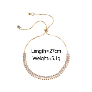 Adjustable golden bracelet with rectangular zircons and sliding clasp detail, 27cm length