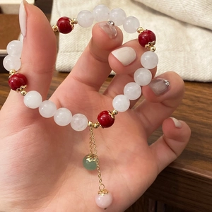 Vintage Chinese style bracelet with red and white stone beads and gold floral accents