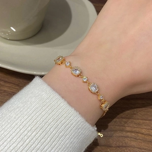 Elegant 18K gold plated bracelet with sparkling zircon stones worn on wrist at teatime