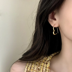 Elegant gold hollow heart earrings for women styled on model for a minimalist fashion look
