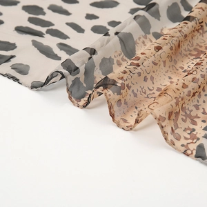 Detail showing sheer leopard print chiffon fabric with mixed animal patterns and textures