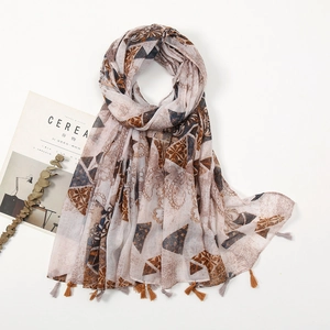 Detailed flat lay of bohemian ethnic scarf with geometric patterns and fringe tassels