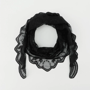 Close-up of black lace triangle scarf featuring delicate scalloped edges and floral embroidery