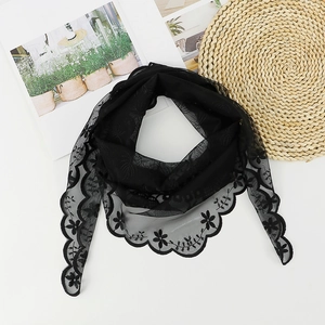 Detailed view of black lace triangular scarf featuring elegant floral embroidery and scalloped edges