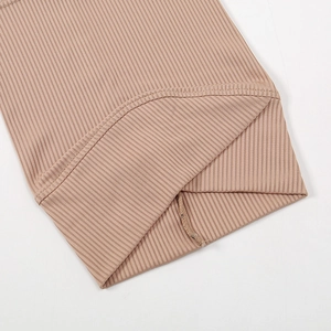 Detailed macro view of khaki ribbed knit fabric showing soft texture and neat stitching