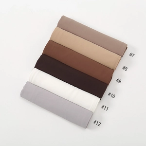 Flat lay of folded chiffon hijabs in earth tones with model numbers seven to twelve