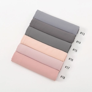 Flat lay of multiple chiffon headscarf color options with stitched edges