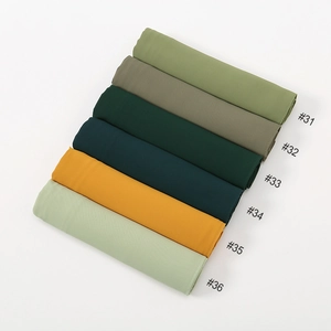 Flat lay of solid color chiffon scarves showing fine machine stitching and texture