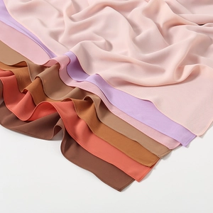 Detail of high-quality chiffon scarves in soft pastel shades showing fabric texture