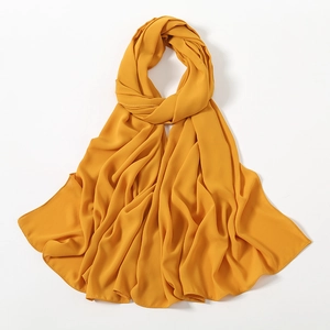 Close-up of golden chiffon hijab featuring fine texture and neat edge stitching details